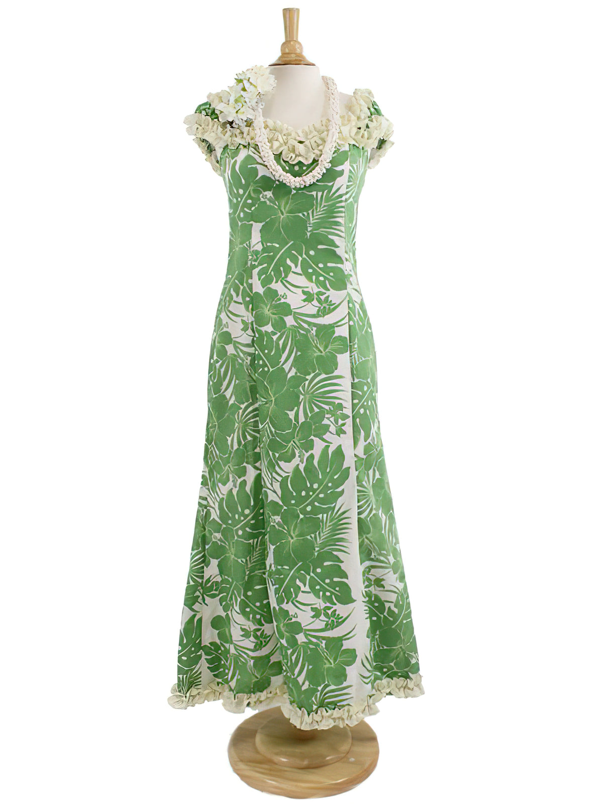 A long Muumuu dress with a green floral pattern, ruffle trim, and elastic shoulder sleeves, displayed on a mannequin.