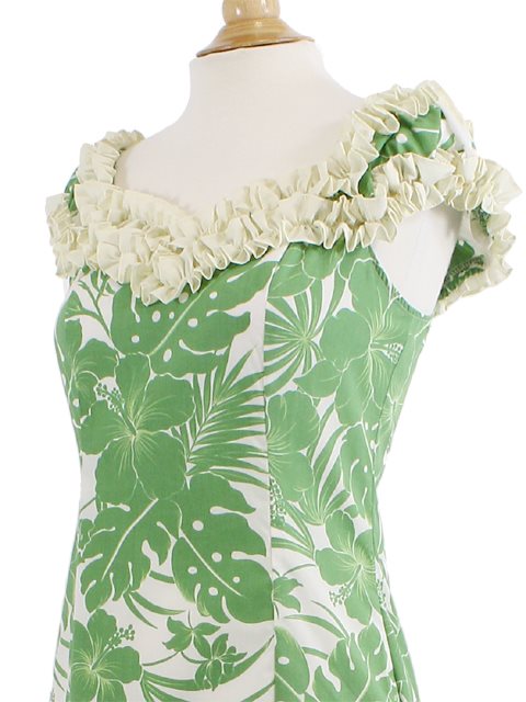 Green and white floral dress on a mannequin with ruffled neckline.