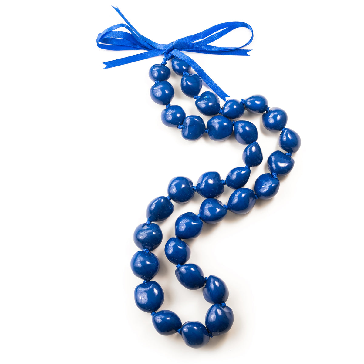 A blue painted kukui nut lei with a blue ribbon.