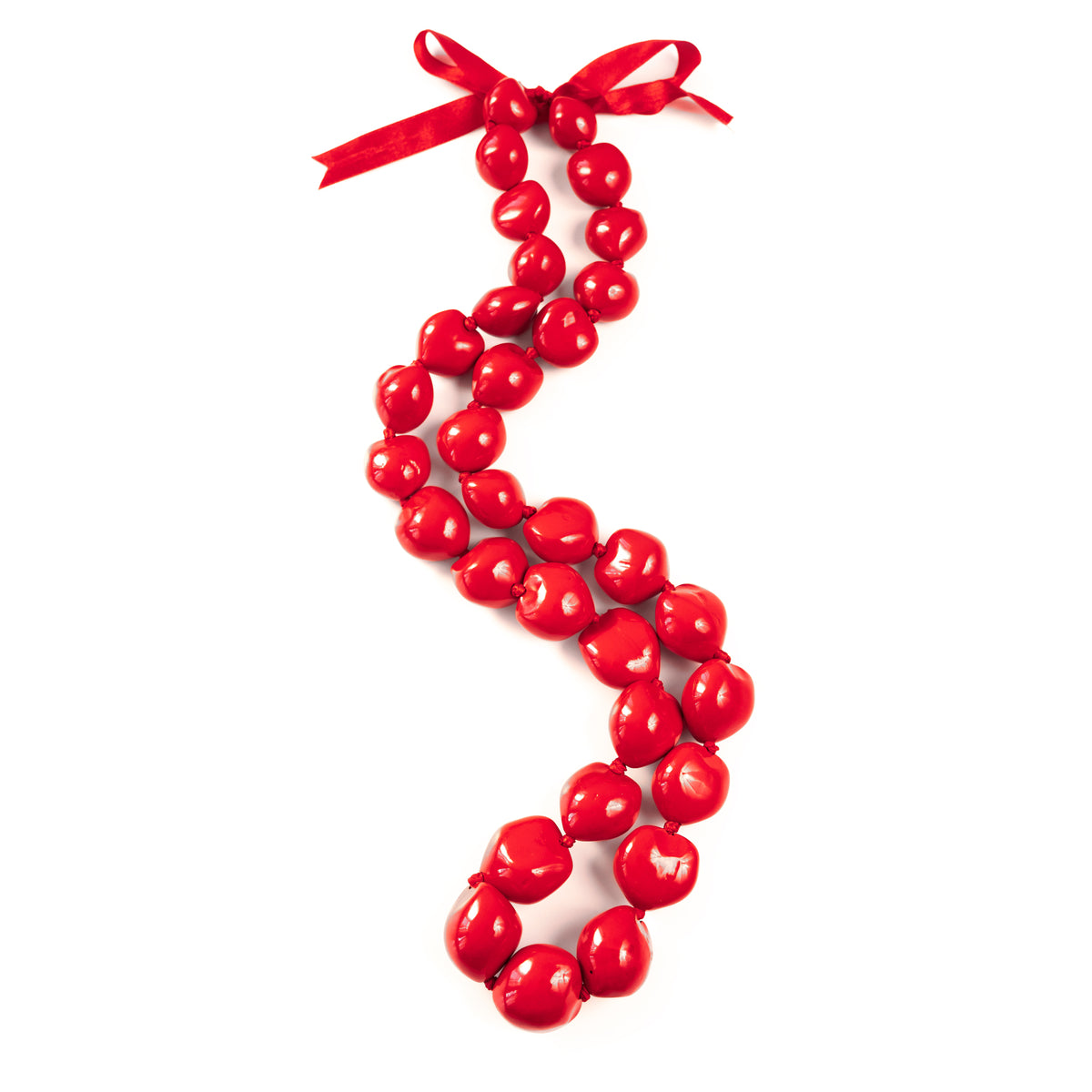 A red painted kukui nut lei with a glossy finish, displayed with a ribbon at the top.